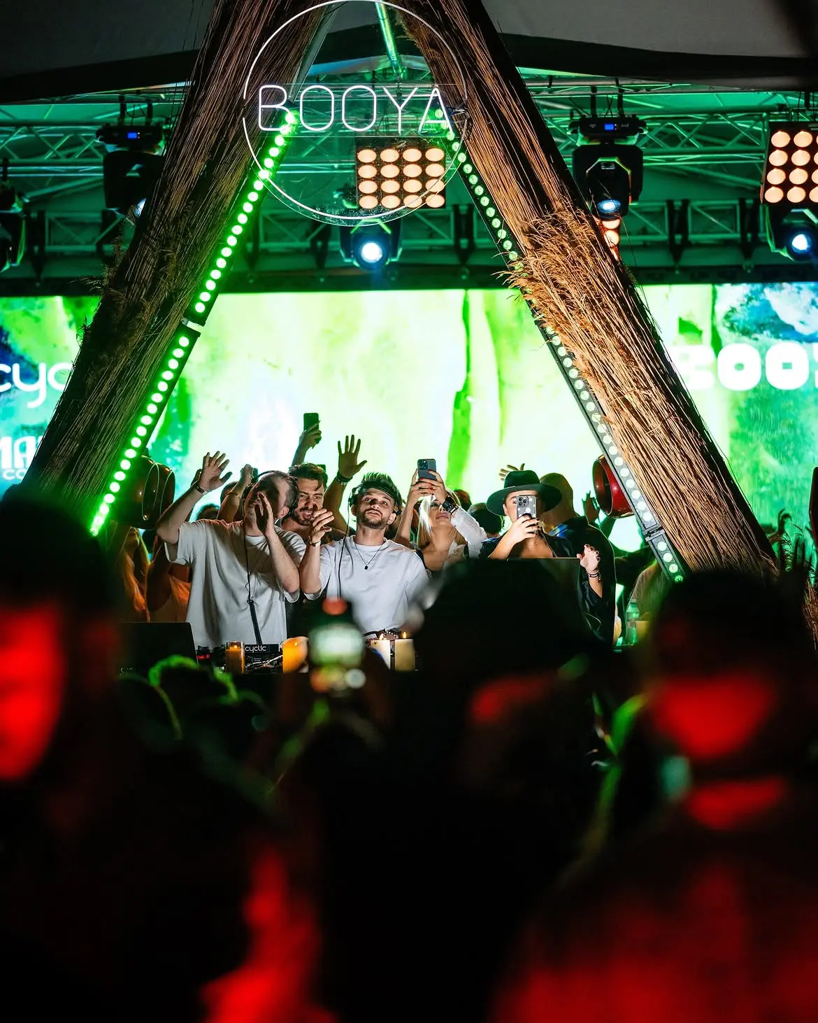 Cloud9 on stage at Booya with the crowd filming under green lights