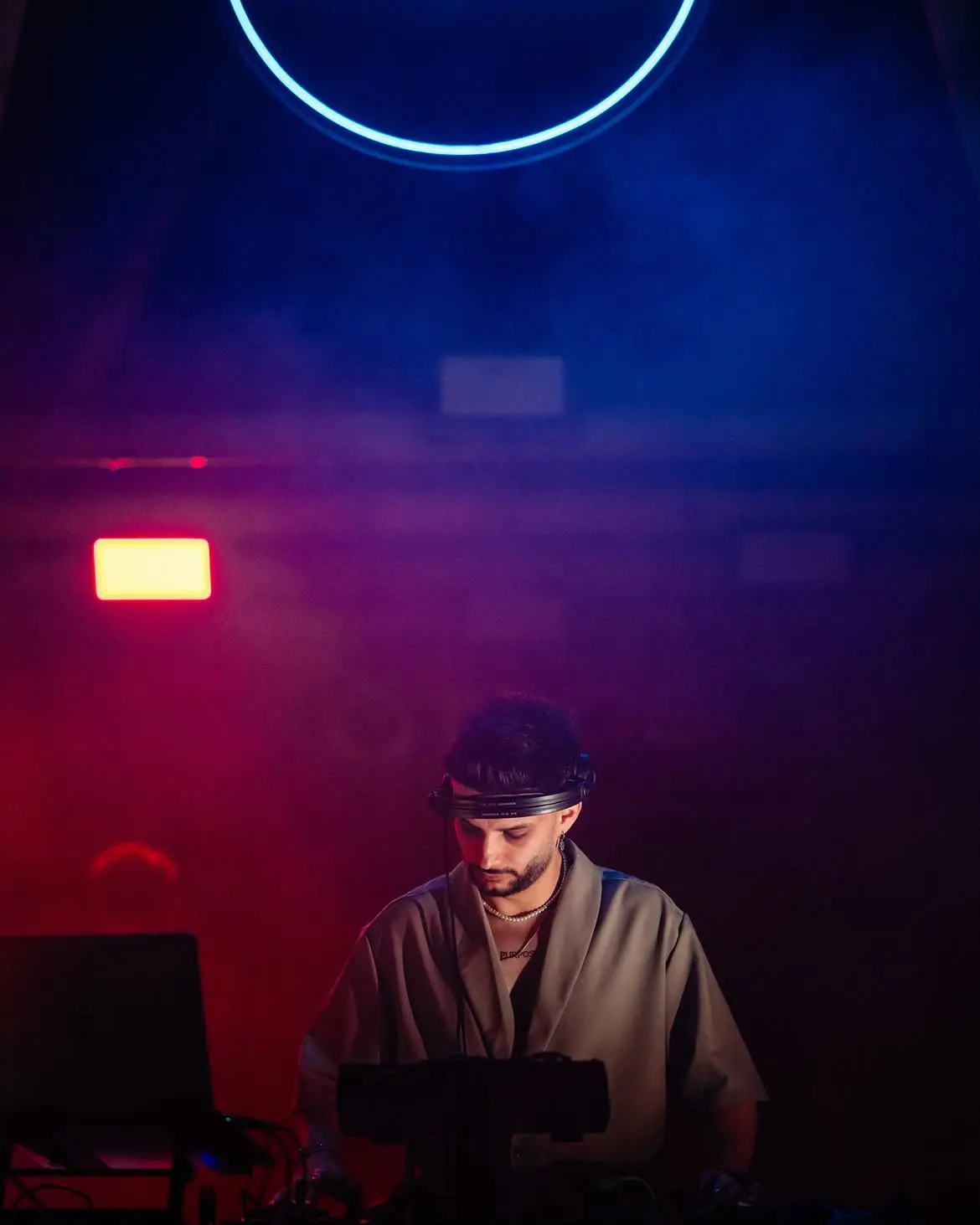 Cloud9 performing under a blue neon ring in red and blue haze